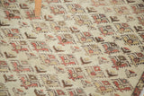Distressed vintage Oushak rug pile, highlighting faded germinating floral motifs and knot heads.