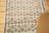 Distressed Turkish Oushak runner with faded floral patterns and visible low pile.