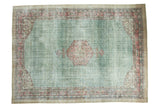Distressed Oushak carpet, muted green, blush diamond herati medallion, ornate floral borders.