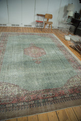 Distressed Turkish Oushak carpet, blush diamond medallion with herati motif, on a soft green field.