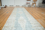 Distressed Turkish Oushak runner, showing faded teal field and geometric sand-toned border.