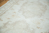 Distressed Oushak rug runner showcasing faded ivory field and light brown patterns.