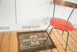 Vintage Oushak rug displaying tribal crab medallion with sand and dark brown patterns.