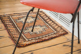 Vintage Oushak rug, geometric tribal rams horn design, barber pole border in brown and tangerine.