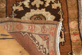 Hand-knotted pile and tight woven foundation of a vintage Turkish Oushak rug in brown tones.
