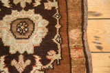 Close-up of vintage Oushak rug's secured side and rich chocolate brown floral pattern.