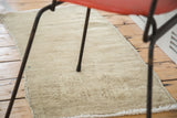 Soft, minimalistic sandy beige hand-knotted texture of vintage Turkish Oushak rug.