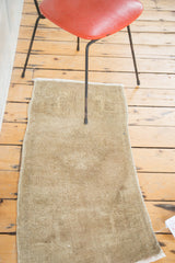 Soft pile texture and tone-on-tone sandy beige field of the vintage Oushak rug.