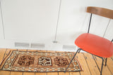 Vintage Oushak runner with two central medallions, 'HASAM' text, and hexagonal border in brown, ivory, and orange.
