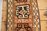 Ivory HASAM text, geometric medallion, and serpent-fill border on vintage Oushak runner.