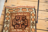 Tangerine and charcoal brown hexagonal serpent cartouches on vintage Oushak rug border.