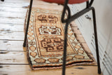 Hexagonal cartouche border with serpent fills on vintage Oushak runner, beige, ivory, faded orange.