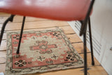 Floral motifs and fully secured edge of a vintage Oushak rug in blush pink.