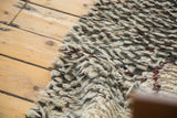 Plush texture of a vintage Moroccan Berber rug, showing natural ivory, charcoal, and wine red wool.
