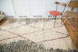 Plush vintage Moroccan carpet pile with asymmetric wine red diamond outlines and speckled charcoal.