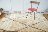 Thick, shaggy ivory wool pile with charcoal lattice pattern on vintage Moroccan rug.