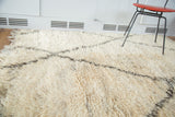 Plush shaggy ivory Moroccan Berber wool texture with charcoal geometric lattice.
