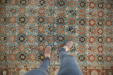 Striated blue field of a vintage Veramin carpet with orange Mina Khani florals and bird motif border.
