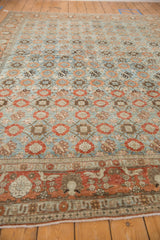 Close-up of vintage Veramin carpet; blue field, Mina Khani floral motifs in faded rust, and bird border.