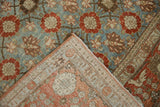 Folded vintage Veramin rug shows blue Mina Khani pattern and intricate woven foundation.