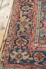Vintage distressed hand-knotted Heriz rug detail, muted blue and peach blush patterns.