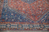 Shiraz carpet's madder red field, indigo pawn design border, and barber pole motifs.