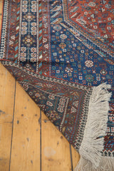 New fringe and reciprocating pawn border on a hand-knotted vintage tribal Shiraz carpet.