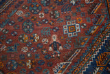 Vintage Shiraz carpet: Detailed person and tribal geometric motifs in madder root red, indigo.