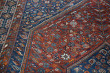 Intricate madder red and indigo blue tribal pinwheel and geometric motifs with even wear.