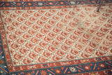 Distressed vintage Malayer rug, repeating red flower motifs on unique ivory field, indigo border.