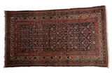 Vintage Kurdish rug with distressed charcoal diamond lattice, rust red florals, 4'2