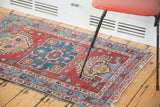Small distressed Persian Heriz rug showing its playful character and colorful palette.