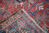 Hand-knotted foundation, fringed edge, and geometric pile of a vintage Heriz carpet.