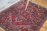 Northwest Persian rug's cherry red geometric floral medallion and navy blue gerus border.