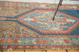 Distressed antique Northwest Persian rug, indigo, green, and rust geometric herati detail.