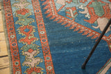 Distressed indigo blue field with rich rust and oxidized green serrated border.