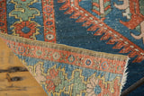 Corner of distressed antique Northwest Persian rug showing blue pile and tight hand-knotted back.