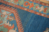 Intricate rust serrated details against the distressed indigo blue field of a Northwest Persian rug.
