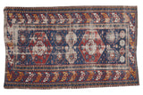 Distressed Antique Shirvan rug with indigo double medallion field, ruby red and ivory geometric pattern.
