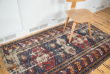 Antique Caucasian Shirvan rug with distressed indigo and red geometric medallion field.