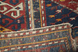 Distressed geometric pile texture and hand-knotted foundation of antique Shirvan rug.