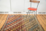 Distressed antique Shirvan rug's rhythmic hexagonal medallions and secure fringe.