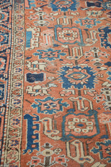 Textured Vintage Heriz rug pile, showcasing madder red, navy, and sky blue harshang motifs.