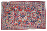 Vintage Arak Sarouk rug, cherry red field, central medallion, royal blue, blush, and lime green floral vines.