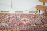 Traditional Persian Arak Sarouk rug with scrolling vines and unique lime green accents.