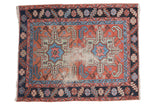 Distressed antique Karaja rug with double medallion, blush field, blue, and time-softened green accents.