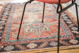 Distressed antique Karaja rug, geometric field in coral, light blue, and deep navy hues.