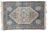 Vintage Persian Abadeh rug with Qashqai stylized central medallion, pale apricot field, and rich blue borders, 3'5