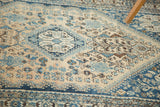 Vintage Abadeh rug's pale apricot field with Qashqai flowers, animals, and blue-brown motifs.