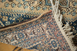 Vintage Abadeh rug corner revealing secured edge, plain weave, and knotted fringe.